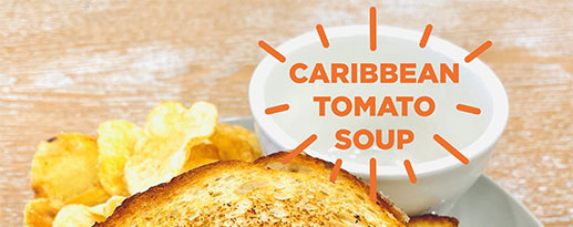 Empty bowl next to a grilled cheese sandwich with the text Caribbean tomato soup