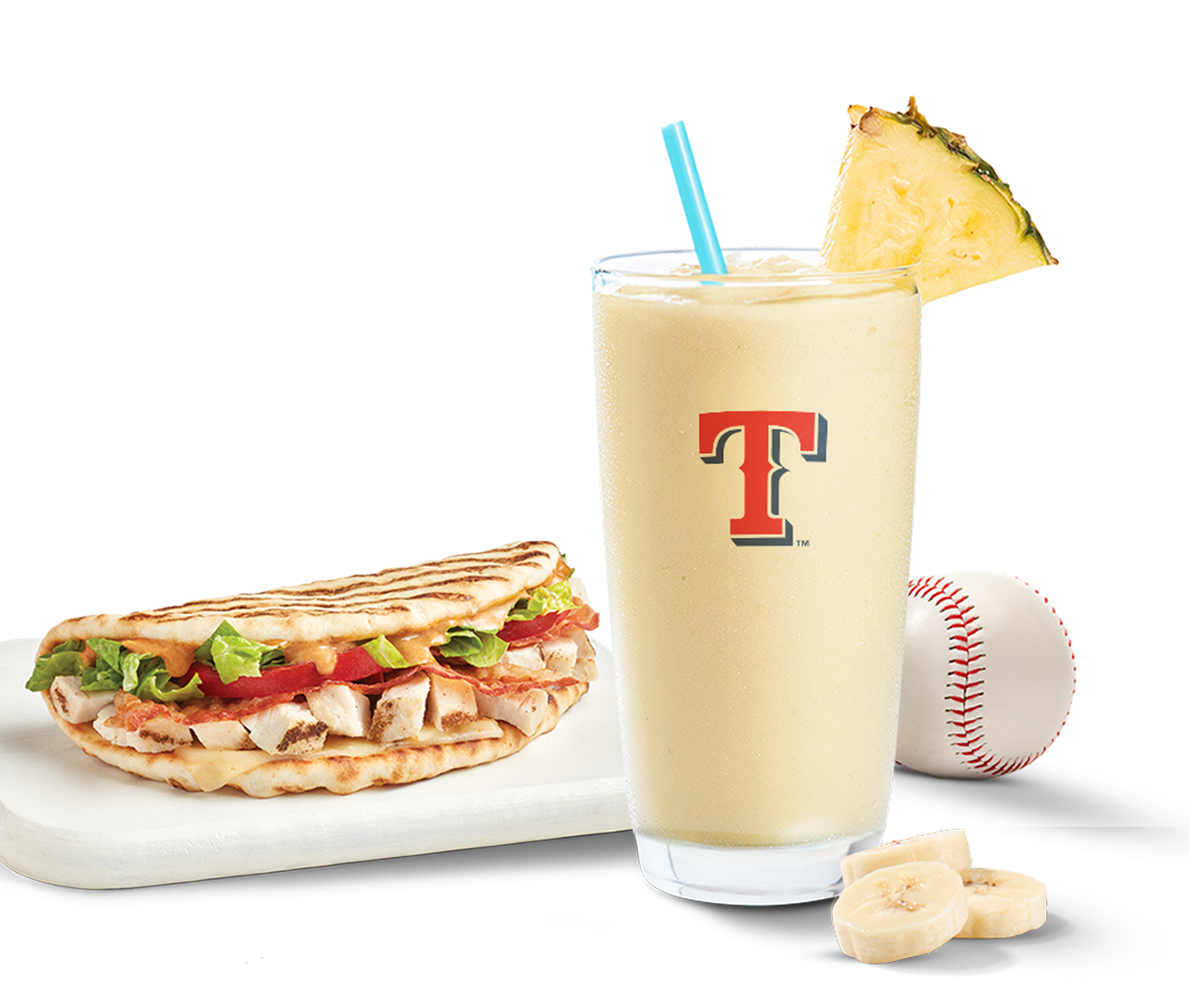 Texas Rangers official Tropicolada smoothie in a glass decorated with a pineapple piece, served together with a Tropical smoothie cafe chipotle chicken club flatbread. 