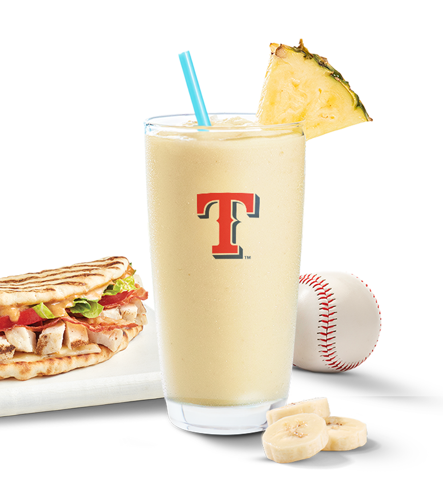 Texas Rangers official Tropicolada smoothie in a glass decorated with a pineapple piece, served together with a Tropical smoothie cafe chipotle chicken club flatbread. 